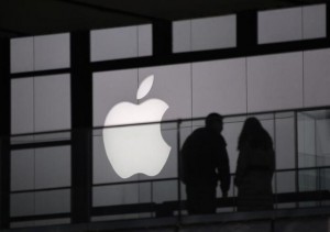 people walking past apple logo