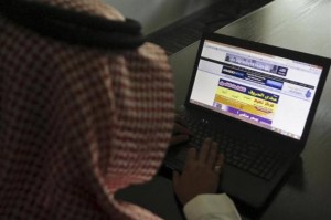 saudi man explores website laptop
