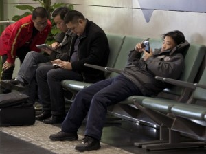 chinese men using mobiles ap