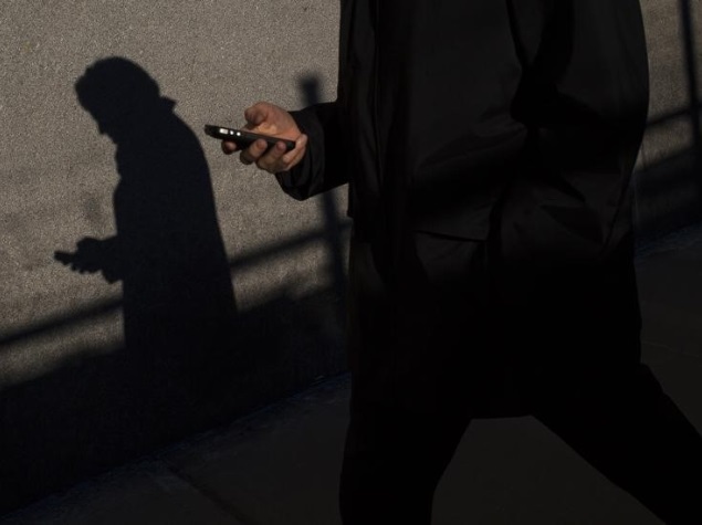 man_using_mobile_while_walking_reuters