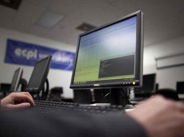 man_working_on_dell_pc_reuters