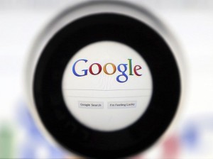 A Google search page is seen through a magnifying glass in this photo illustration taken in Brussels