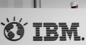 File photo shows a worker behind a logo at the IBM stand on the CeBIT computer fair in Hanover