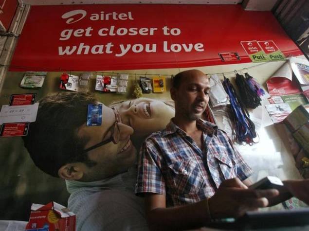 man using mobile in airtel store