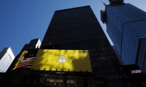 A billboard displays the logo of Snapchat above Times Square in New York